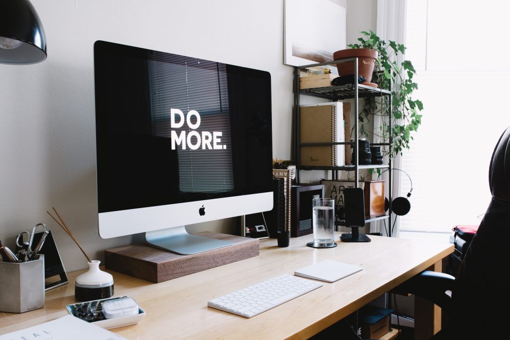 Computer on a desk. Written on screen: Do More.