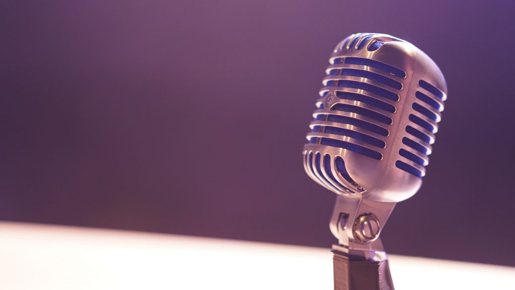 Vintage microphone with purple muted background.