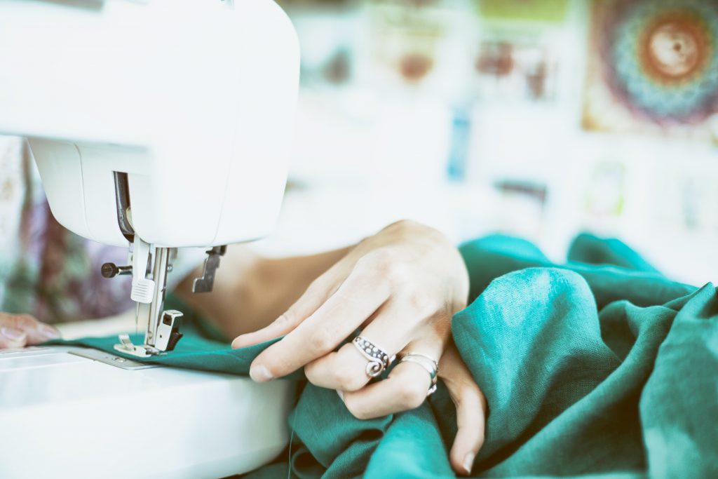 Woman sewing fabric on a sewing machine